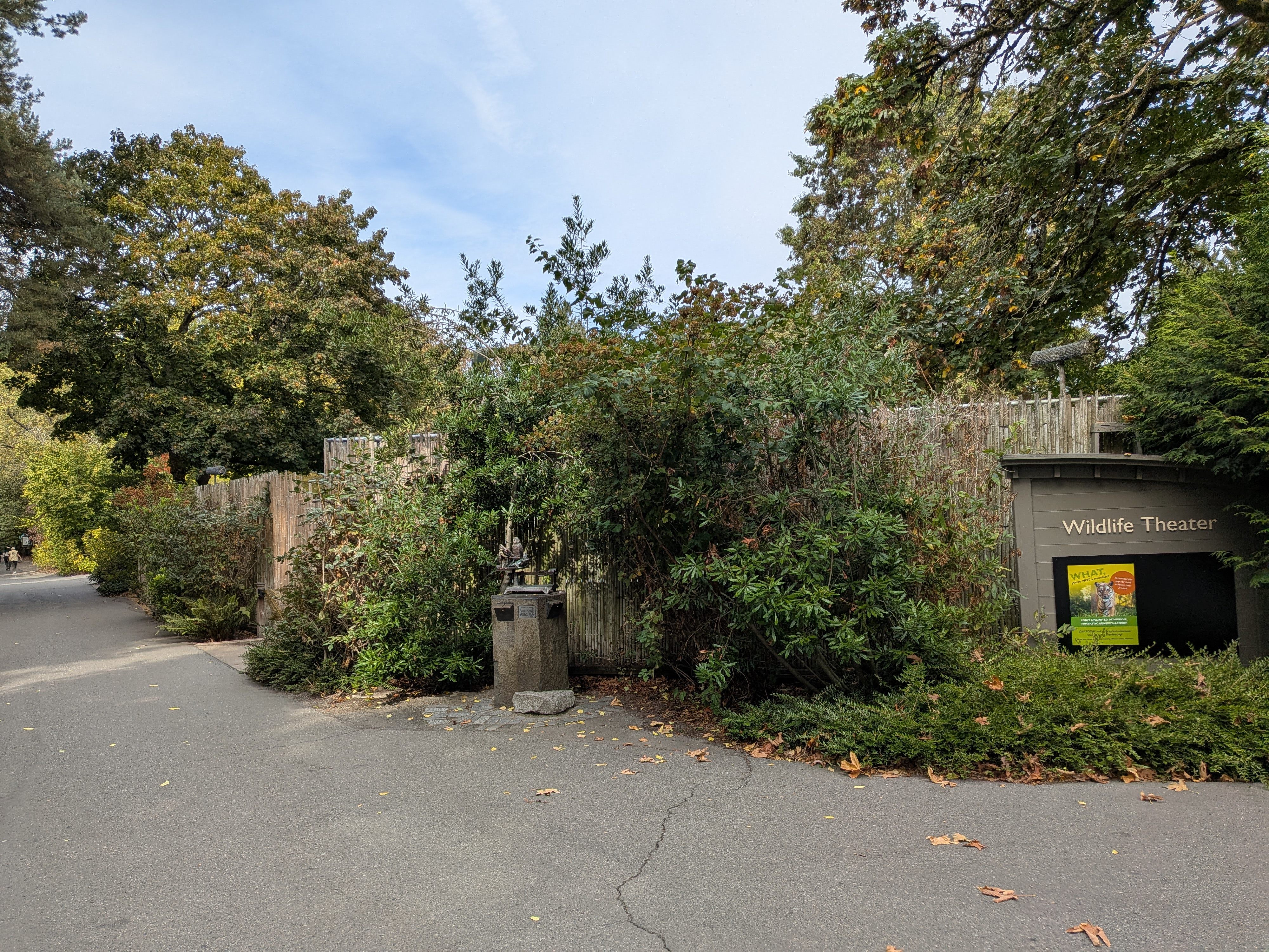 Image depicting the location of Together as One art. To the right of the bronze statue is a sign titled "Wildlife Theater."